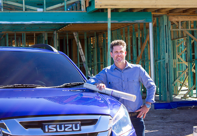 Headshot of Dave Wayman standing next to his Isuzu vehicle