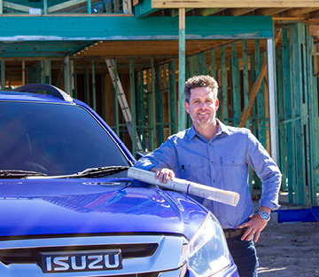 Headshot of Dave Wayman standing next to his Isuzu vehicle