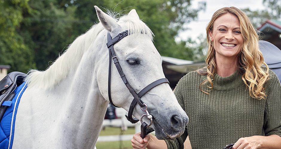 Headshot of Deb Wayman standing next to a horse