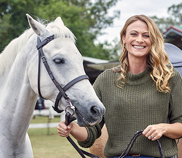 Headshot of Deb Wayman standing next to a horse