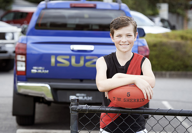 Zac Wayman standing in front of an Isuzu D-MAX